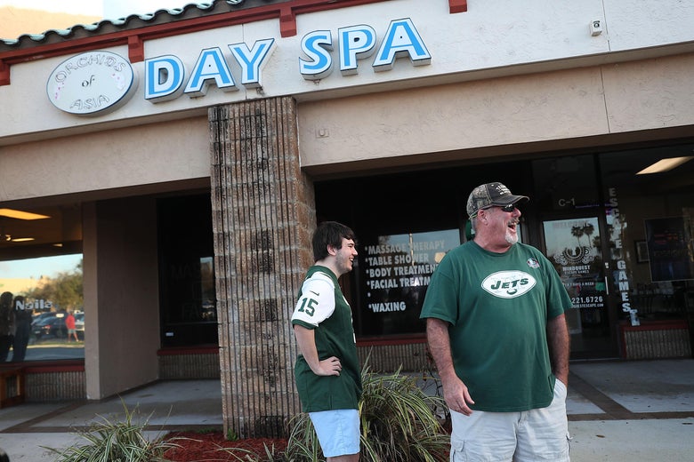 Matthew Gizze (L) and Kevin Brown, both of whom are N.Y. Jet football fans, stop to look at the Orchids of Asia Day Spa where New England Patriots owner Robert Kraft is charged with allegedly soliciting for sex on February 22, 2019 in Jupiter, Florida.